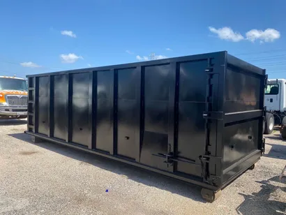 Park N Dump 40 yard roll-off dumpster in a gravel yard